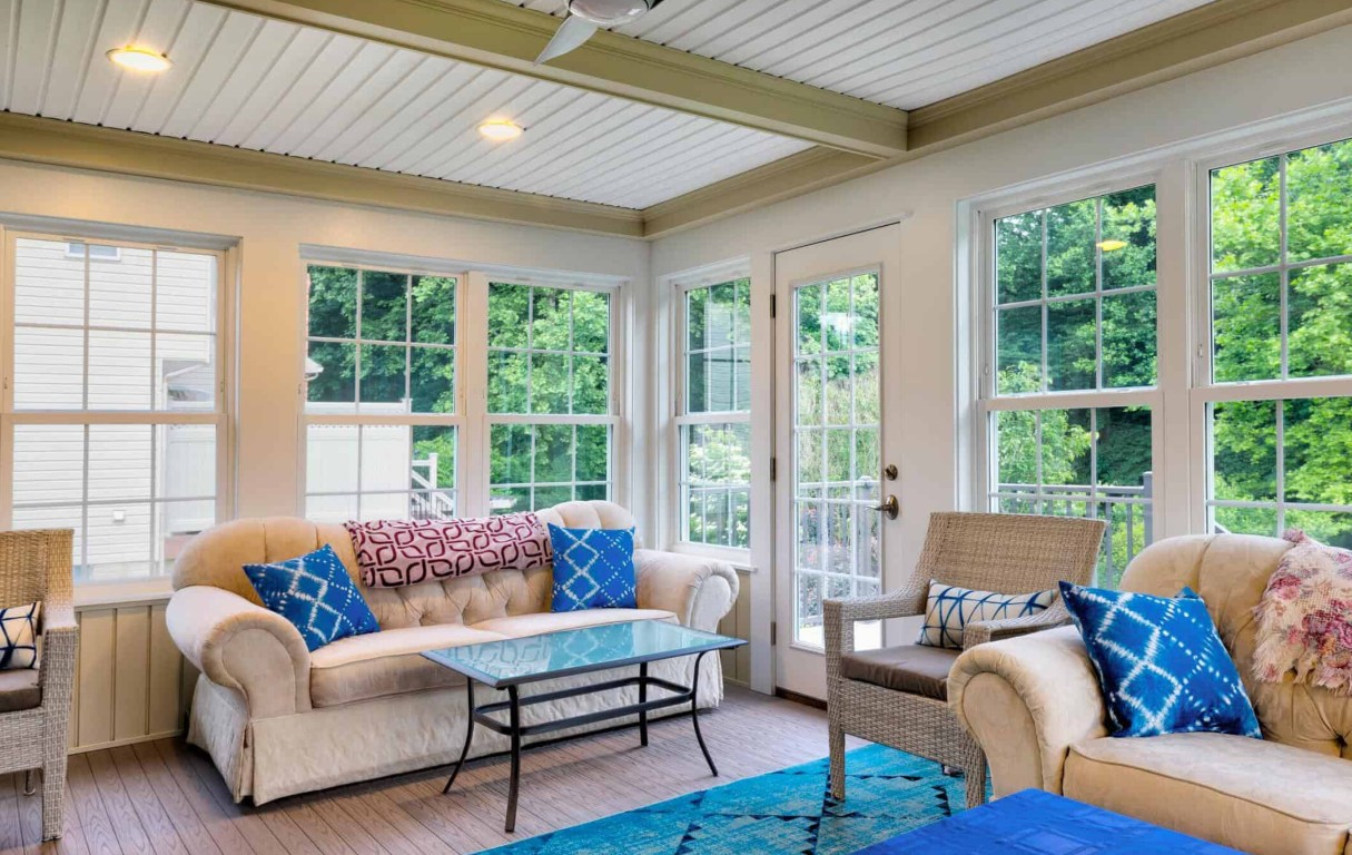 Newly installed sunroom with large windows and comfortable seating