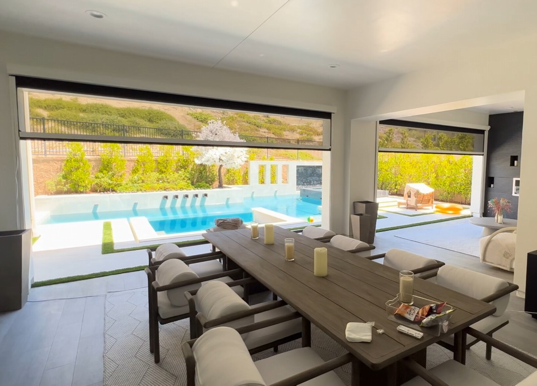 Upgraded luxury sunroom with poolside view through large windows