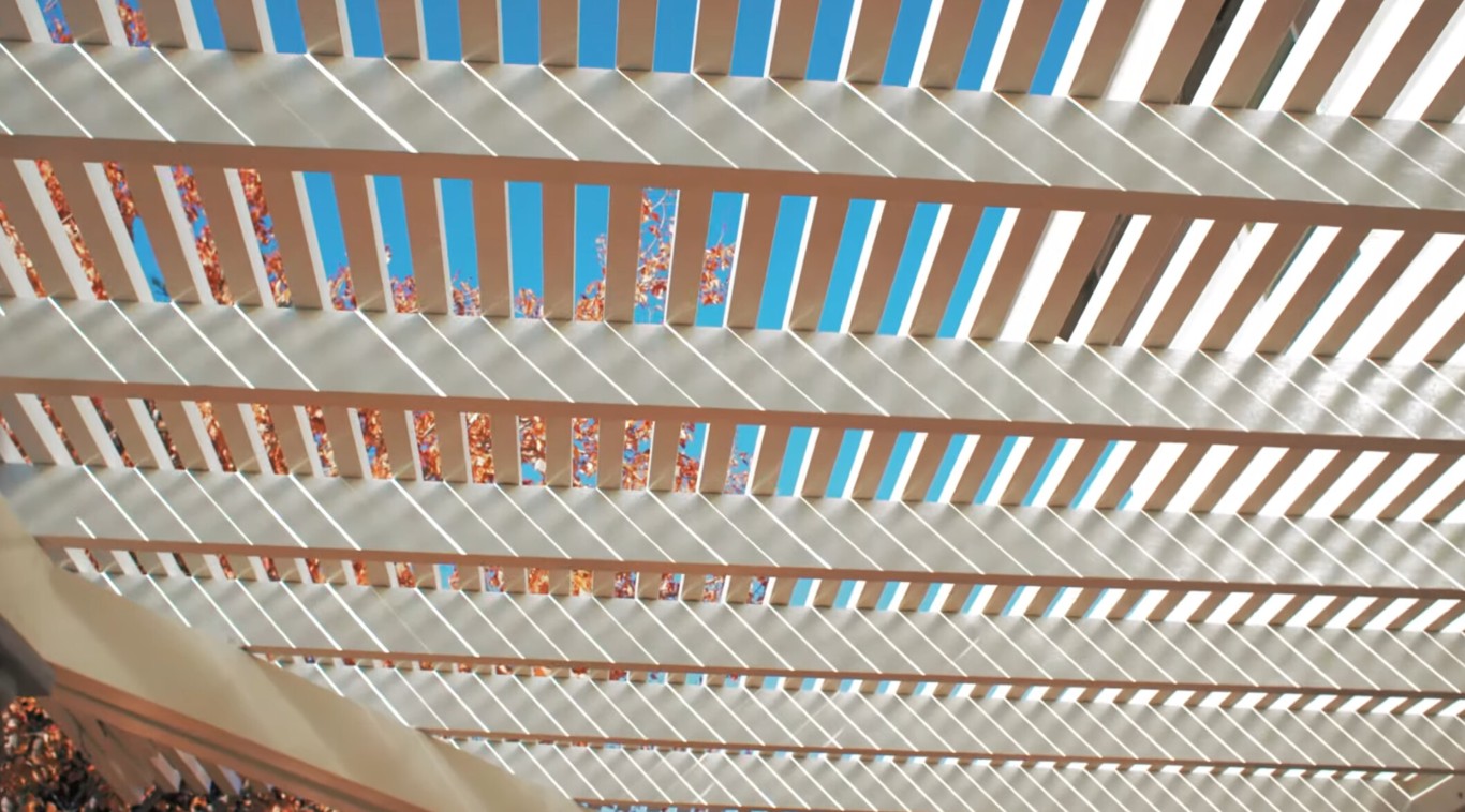 White pergola with decorative slatted ceiling design